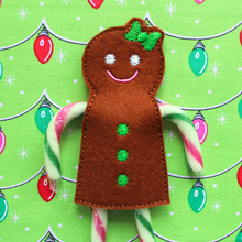 Load image into Gallery viewer, Gingerbread girl candy cane holder stitched in brown felt with green bow and buttons
