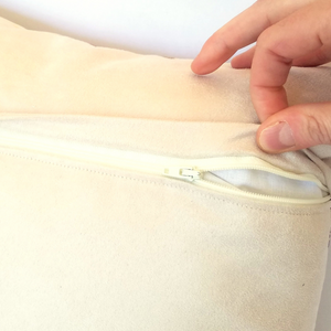 Cushion reverse in cream with a zip opening