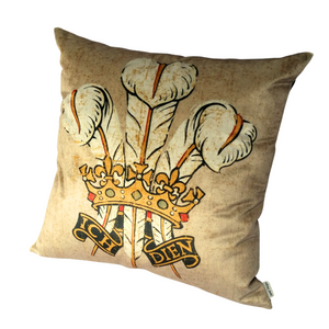 Three Feathers cushion in beige velvet with golden crown and the words Ich Dien